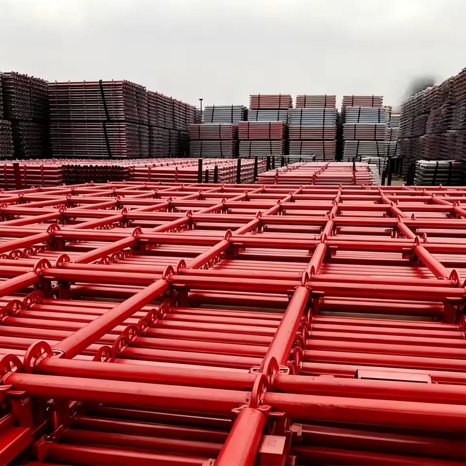 Red painted scaffolding frames stacked in the yard